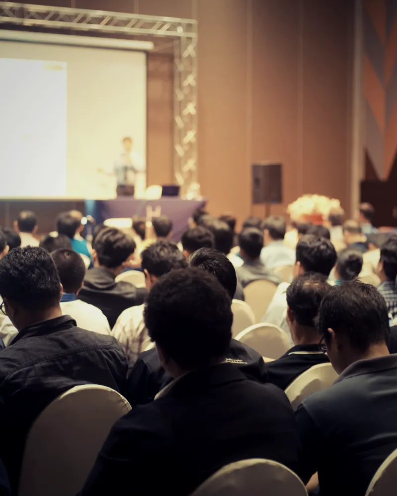 Crowded conference audience facing the stage